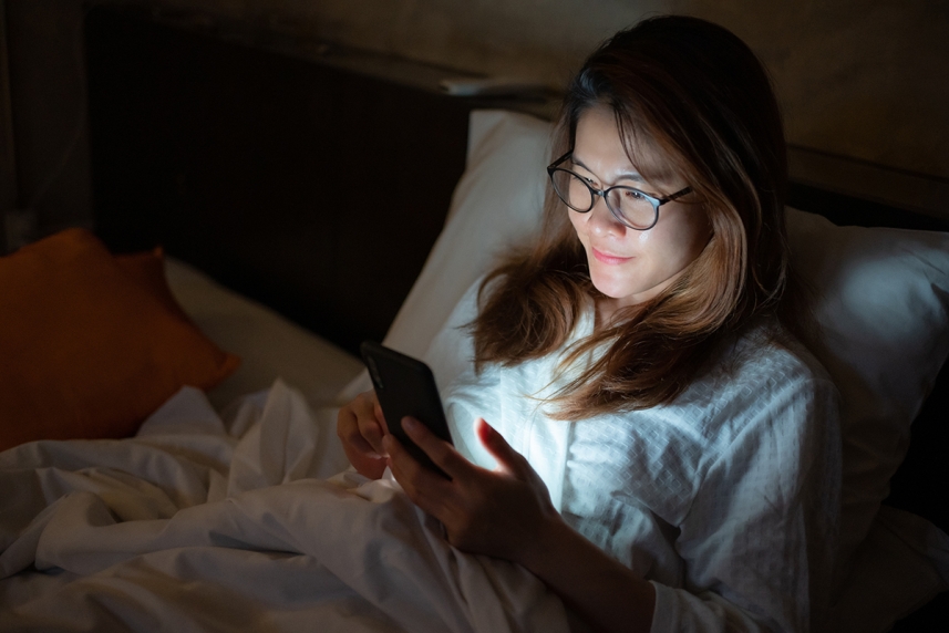 Person using the phone right before bedtime