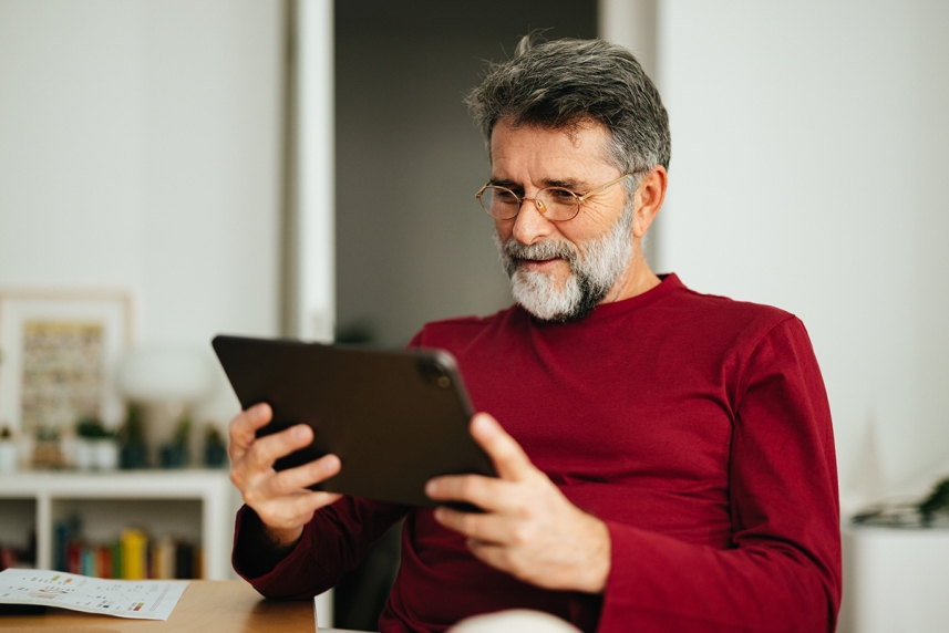 An adult man wearing computer glasses to help ease eye strain 