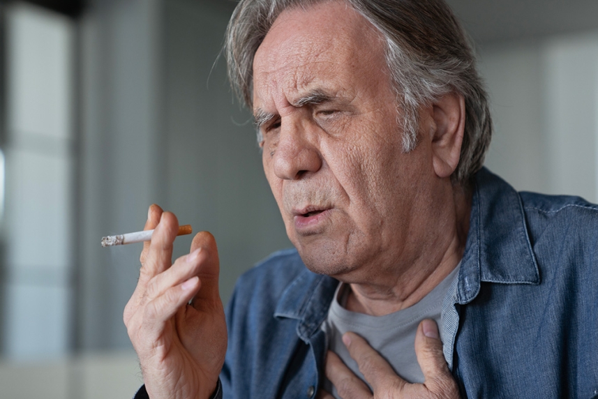 Older adult man thinking about stopping smoking and saving his eyesight