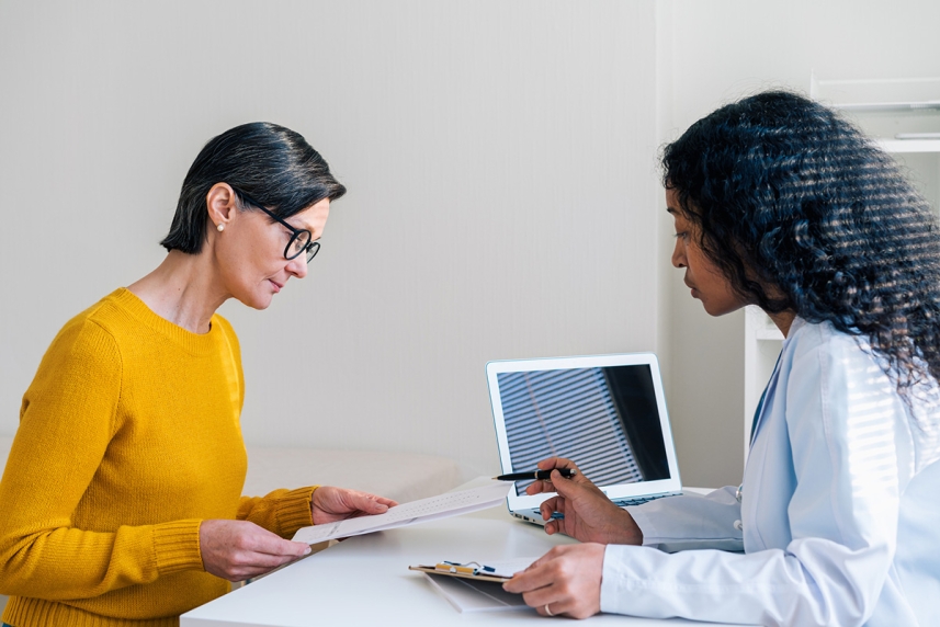 An adult woman consults with her eye doctor about LASIK surgery 