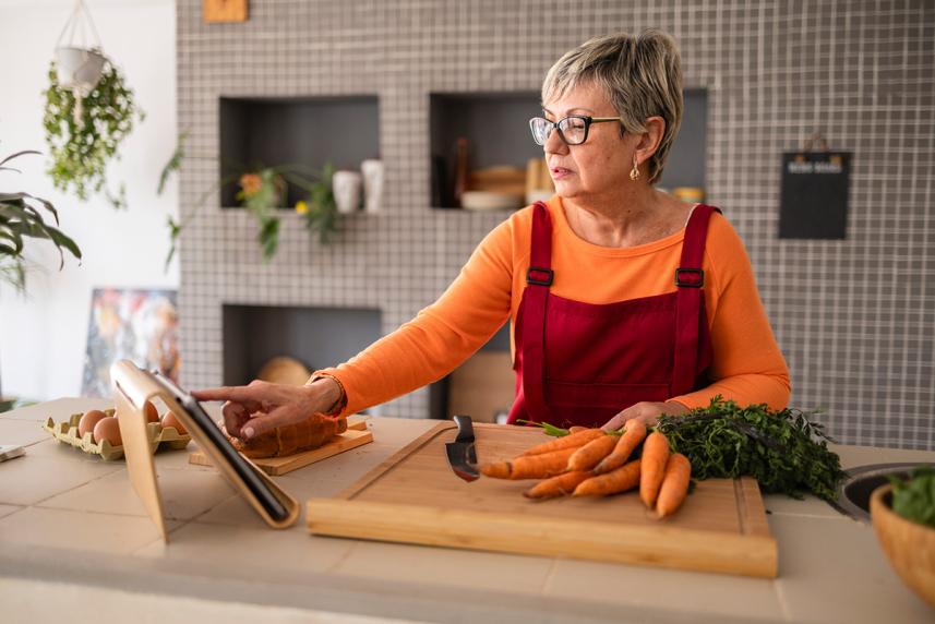 Woman on tablet while cooking