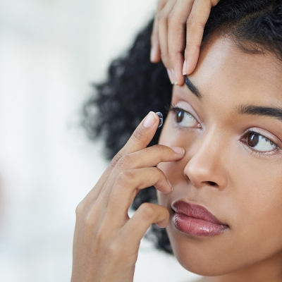 A woman putting in her contacts