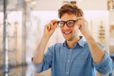 A man trying on a pair of glasses in a store