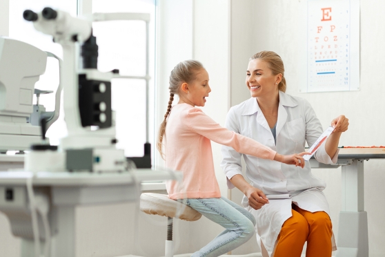 A young girl talks with her eye care provider about color blindness