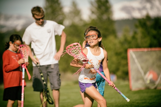 Young female kid playing lacrosse