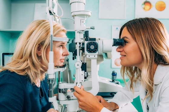 Eye doctor examining a female patient with diabetes