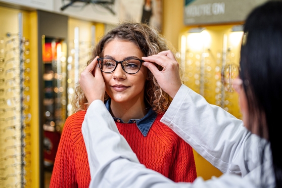 Young adult female trying on glasses