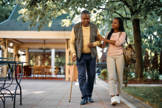 Senior man walking with daughter outside
