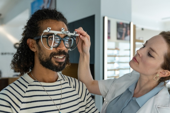 An adult man tapping into his UnitedHealthcare Vision benefits