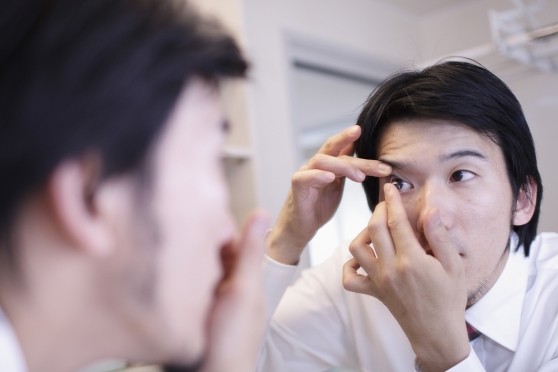 An adult man managing nearsightedness without glasses 