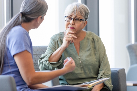 Older woman talking with her eye doctor before cataract surgery 