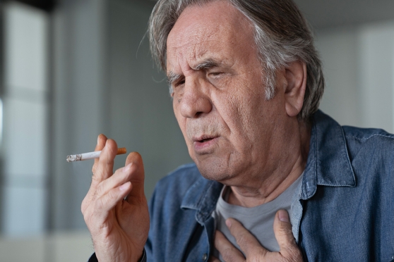 Older adult man thinking about stopping smoking and saving his eyesight