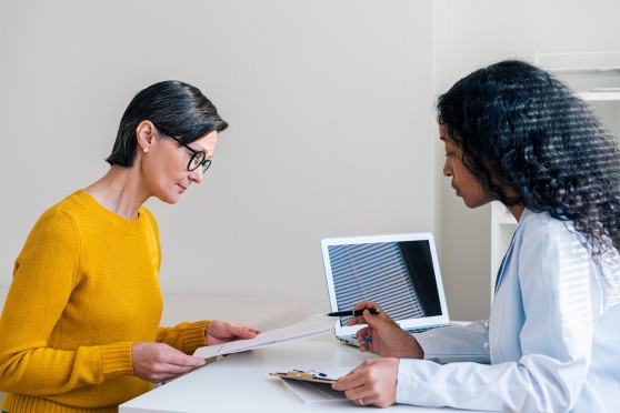 An adult woman consults with her eye doctor about LASIK surgery 