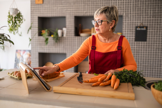 Woman on tablet while cooking