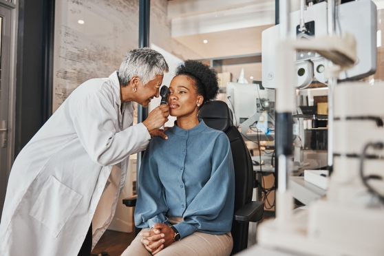 An eye doctor doing a contact lens exam and fitting 
