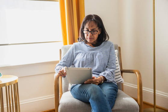 Woman on tablet in her living room
