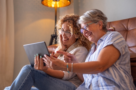 Older adult woman and her adult daughter reviewing their family history for glaucoma